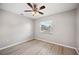 Bedroom showcasing wood flooring, a ceiling fan, a window, and neutral colored walls at 707 Laurel Pointe Ct, Lakeland, FL 33813