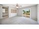 Spacious carpeted bedroom features natural light, sliding glass doors, and ensuite access to the bathroom at 707 Laurel Pointe Ct, Lakeland, FL 33813