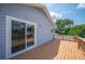 Exterior of house showing the wooden deck and sliding glass doors leading into the bedroom at 707 Laurel Pointe Ct, Lakeland, FL 33813