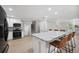 Bright kitchen featuring white cabinets, stainless steel appliances, an island, and wood floors at 707 Laurel Pointe Ct, Lakeland, FL 33813