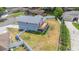 Aerial view of home highlighting spacious yard, wooden deck, screened patio, and white privacy fence at 707 Laurel Pointe Ct, Lakeland, FL 33813