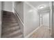 Carpeted stairway leading to the second floor, complimented by light grey walls and contrasting white trim at 707 Laurel Pointe Ct, Lakeland, FL 33813