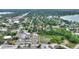 Aerial view of a neighborhood with mature trees, a small pond, and some industrial buildings at 716 S Franklin Pl, Lakeland, FL 33815