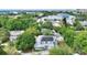 Aerial view of the two-story home with solar panels, surrounded by lush greenery in an urban location at 716 S Franklin Pl, Lakeland, FL 33815