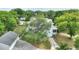 Aerial view of a two-story home surrounded by mature trees with a detached garage at 716 S Franklin Pl, Lakeland, FL 33815