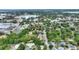 Aerial view of a residential neighborhood with mature trees and a small lake and downtown buildings nearby at 716 S Franklin Pl, Lakeland, FL 33815