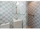 Cozy bathroom featuring checkered tile and walk-in shower at 716 S Franklin Pl, Lakeland, FL 33815