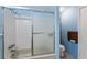 Well-maintained bathroom with a shower-tub combo and frosted sliding door at 716 S Franklin Pl, Lakeland, FL 33815