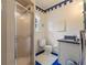 Well-lit bathroom featuring a shower, toilet, sink, and tiled walls and floors at 716 S Franklin Pl, Lakeland, FL 33815