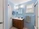 Cozy blue bathroom featuring a vanity, sink, mirror, and window with natural light at 716 S Franklin Pl, Lakeland, FL 33815