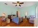 This bedroom boasts wood floors, fresh paint, a ceiling fan and ample space at 716 S Franklin Pl, Lakeland, FL 33815