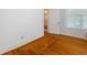 Bedroom with hardwood floors and view into the hall at 716 S Franklin Pl, Lakeland, FL 33815