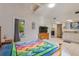 Bright bedroom featuring a colorful quilt, skylight, and an ensuite bathroom with updated vanity at 716 S Franklin Pl, Lakeland, FL 33815