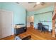 Light blue bedroom with hardwood floors, large windows, and a vintage-style desk at 716 S Franklin Pl, Lakeland, FL 33815