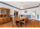 Elegant dining room featuring hardwood floors, classic wallpaper, and a charming wooden hutch at 716 S Franklin Pl, Lakeland, FL 33815