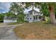 Two-story home featuring a lush lawn, a detached garage and a sunroom at 716 S Franklin Pl, Lakeland, FL 33815