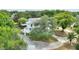 Charming two-story home with a covered parking area and beautiful, mature trees surrounding the property at 716 S Franklin Pl, Lakeland, FL 33815