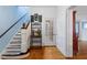 Inviting foyer with hardwood floors, staircase, and charming decor at 716 S Franklin Pl, Lakeland, FL 33815