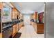 Functional kitchen with wooden cabinets, black countertops, and stainless steel appliances, blending style and convenience at 716 S Franklin Pl, Lakeland, FL 33815