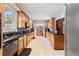 Spacious galley kitchen with sleek black countertops and ample wooden cabinets, perfect for cooking enthusiasts at 716 S Franklin Pl, Lakeland, FL 33815