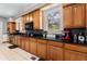 Charming kitchen with wooden cabinets, mosaic backsplash, and modern appliances, offering both style and functionality at 716 S Franklin Pl, Lakeland, FL 33815
