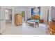 Bright and airy bedroom with white floors, a wooden bed frame, and a colorful painting at 716 S Franklin Pl, Lakeland, FL 33815