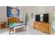 Inviting bedroom featuring bright, natural light, wood furnishings, and a television at 716 S Franklin Pl, Lakeland, FL 33815