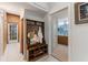Inviting mudroom with a convenient bench, shoe storage, and coat rack, leading to a brightly lit bathroom at 716 S Franklin Pl, Lakeland, FL 33815