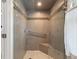 Updated shower featuring stylish tile work, a glass door, and a convenient grab bar at 716 S Franklin Pl, Lakeland, FL 33815