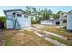 Home exterior with stairs, detached garage and partial view of backyard at 717 Frank Lloyd Wright Way, Lakeland, FL 33803