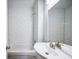 This bathroom features a tiled shower and walls and a modern sink at 717 Frank Lloyd Wright Way, Lakeland, FL 33803