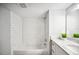 Bright bathroom with a tiled shower and updated vanity with marble countertop at 717 Frank Lloyd Wright Way, Lakeland, FL 33803