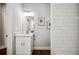 Bathroom vanity with white marble countertop and silver faucet and tile accent wall at 717 Frank Lloyd Wright Way, Lakeland, FL 33803