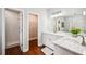 Updated bathroom features a double vanity, walk-in shower, and wood floors at 717 Frank Lloyd Wright Way, Lakeland, FL 33803
