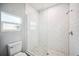 Modern bathroom with subway tile shower, glass door, marble floor, and toilet at 717 Frank Lloyd Wright Way, Lakeland, FL 33803