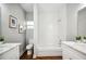 Bright bathroom featuring subway tile shower, marble countertop vanity, and wood-look flooring at 717 Frank Lloyd Wright Way, Lakeland, FL 33803
