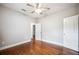 This bedroom boasts hardwood floors, neutral paint, and a ceiling fan at 717 Frank Lloyd Wright Way, Lakeland, FL 33803