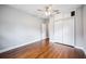 Bright bedroom features hardwood floors, a ceiling fan, and a closet at 717 Frank Lloyd Wright Way, Lakeland, FL 33803