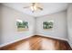 Bedroom featuring hardwood floors and windows with a view of the outdoors at 717 Frank Lloyd Wright Way, Lakeland, FL 33803