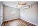 Bedroom with wood-look flooring, ceiling fan, and a window with bright natural light at 717 Frank Lloyd Wright Way, Lakeland, FL 33803