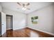 Bedroom with ceiling fan, hardwood floors, and open closet at 717 Frank Lloyd Wright Way, Lakeland, FL 33803