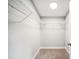 Walk-in closet boasts wire shelving and carpeted flooring at 717 Frank Lloyd Wright Way, Lakeland, FL 33803