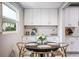 Cozy dining area filled with natural light from the window and view of white cabinetry at 717 Frank Lloyd Wright Way, Lakeland, FL 33803