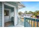 This entryway features a blue railing and a view of the neighboring home at 717 Frank Lloyd Wright Way, Lakeland, FL 33803