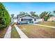 Inviting craftsman home with manicured lawn, sidewalk and mature trees at 717 Frank Lloyd Wright Way, Lakeland, FL 33803