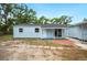 Charming, light blue single-story home with a well-manicured front yard at 717 Frank Lloyd Wright Way, Lakeland, FL 33803