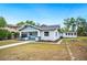 Craftsman-style home featuring a covered porch and verdant lawn at 717 Frank Lloyd Wright Way, Lakeland, FL 33803