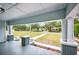 Inviting front porch with classic columns and a view of the neighborhood street at 717 Frank Lloyd Wright Way, Lakeland, FL 33803