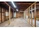 The unfinished garage offers concrete floors and an unfinished wood frame at 717 Frank Lloyd Wright Way, Lakeland, FL 33803