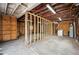 The unfinished garage includes wood framing, a water heater and a washing machine at 717 Frank Lloyd Wright Way, Lakeland, FL 33803